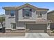 Charming two-story home features a symmetrical facade, desert landscaping, and a two car garage at 1317 N Balboa --, Mesa, AZ 85205
