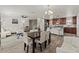 Open-concept space showcasing living and dining areas, connecting seamlessly to a kitchen island with bar seating at 1317 N Balboa --, Mesa, AZ 85205