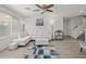 Bright living area featuring a white sectional, stylish lighting, and wood-look floors at 1317 N Balboa --, Mesa, AZ 85205