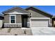 Inviting single-story home with a neutral color palette, stone accents, and a two-car garage at 13212 E Verbina Ln, Florence, AZ 85132