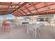 Covered outdoor area with foosball table, dining tables, and access to the community pool at 13212 E Verbina Ln, Florence, AZ 85132