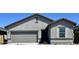 Contemporary home design with a gray color scheme, featuring a two-car garage and desert landscaping at 13254 E Verbina Ln, Florence, AZ 85132