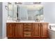 A bathroom featuring a double sink vanity with ample cabinet space, set against a soothing blue wall color at 13259 W Flower St, Litchfield Park, AZ 85340