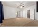 Expansive bedroom showcasing carpet flooring, double doors to the outside, and an entrance to another room at 13259 W Flower St, Litchfield Park, AZ 85340