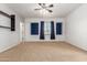 Carpeted bedroom with unique recessed windows and blue curtains, creating a cozy and modern aesthetic at 13259 W Flower St, Litchfield Park, AZ 85340