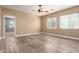 Large bedroom with tile flooring, ceiling fan, two windows, and tan walls at 13259 W Flower St, Litchfield Park, AZ 85340