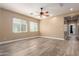 Large bedroom featuring a ceiling fan, wood-look flooring, and two windows for natural light at 13259 W Flower St, Litchfield Park, AZ 85340