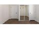 Bedroom featuring mirrored closet and tiled flooring at 13259 W Flower St, Litchfield Park, AZ 85340
