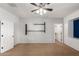 A bedroom featuring carpeted floors, neutral paint, a ceiling fan, and a connecting door to another room at 13259 W Flower St, Litchfield Park, AZ 85340