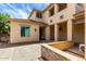 Two-story home featuring an extended loggia, desert landscaping, and neutral color scheme under a blue sky at 13259 W Flower St, Litchfield Park, AZ 85340