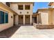 Two-story home featuring an extended loggia, desert landscaping, and neutral color scheme under a blue sky at 13259 W Flower St, Litchfield Park, AZ 85340