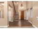 Grand foyer featuring high ceilings, tile flooring, traditional dark wood door and a staircase at 13259 W Flower St, Litchfield Park, AZ 85340
