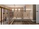 Upstairs hallway featuring decorative iron balusters overlooking the lower level and wood-look flooring at 13259 W Flower St, Litchfield Park, AZ 85340