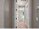 A bright hallway with tile flooring leads to a sunlit room, offering a welcoming transition in the home at 13259 W Flower St, Litchfield Park, AZ 85340