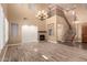 Bright living room with a stone fireplace and staircase at 13259 W Flower St, Litchfield Park, AZ 85340