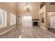 Bright living room with a stone fireplace and wood-look tile flooring at 13259 W Flower St, Litchfield Park, AZ 85340