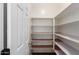 Walk-in pantry features multiple shelves and patterned shelf liners providing ample storage at 13259 W Flower St, Litchfield Park, AZ 85340