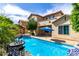 Sparkling pool surrounded by tropical foliage, complemented by elegant decor at 13259 W Flower St, Litchfield Park, AZ 85340