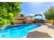 Inviting backyard pool with elegant water features at 13259 W Flower St, Litchfield Park, AZ 85340