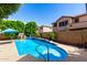 Beautiful backyard pool with fountains and tropical landscaping at 13259 W Flower St, Litchfield Park, AZ 85340