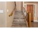 Tile staircase with wood railings and decorative iron balusters leads to the upper level of the home at 13259 W Flower St, Litchfield Park, AZ 85340