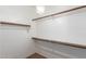 Walk-in closet with shelving, bar and lighting fixture at 13259 W Flower St, Litchfield Park, AZ 85340