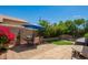 Inviting backyard with patio seating, lush greenery, block wall, and a well-maintained lawn at 13421 W Ocotillo Ln, Surprise, AZ 85374