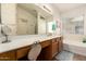 Bathroom features a long vanity, a bathtub, and a neutral color palette at 13421 W Ocotillo Ln, Surprise, AZ 85374
