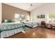 Inviting bedroom boasts twin beds, a ceiling fan, and natural light at 13421 W Ocotillo Ln, Surprise, AZ 85374