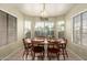Bright dining room with large windows and classic wooden table at 13421 W Ocotillo Ln, Surprise, AZ 85374