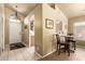 Open-concept entryway with neutral walls and tile flooring, leading to dining area and other rooms at 13421 W Ocotillo Ln, Surprise, AZ 85374