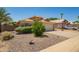 Charming single-story home with a well-maintained front yard, desert landscaping, and a two-car garage at 13421 W Ocotillo Ln, Surprise, AZ 85374