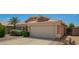 Charming single-story home with a well-maintained front yard, desert landscaping, and a two-car garage at 13421 W Ocotillo Ln, Surprise, AZ 85374