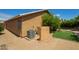 Exterior view of the home highlighting the stucco siding, AC unit, and manicured landscaping around the perimeter at 13421 W Ocotillo Ln, Surprise, AZ 85374
