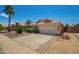 Charming single-story home with a well-maintained front yard, desert landscaping, and a two-car garage at 13421 W Ocotillo Ln, Surprise, AZ 85374