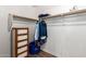 Organized walk-in closet featuring a wooden shelf, wooden pole, and chest of drawers for clothing storage at 13421 W Ocotillo Ln, Surprise, AZ 85374