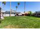 Expansive backyard with green lawn, patio, and privacy fencing at 14008 N 61St Ave, Glendale, AZ 85306