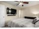 This bedroom features a ceiling fan, carpet flooring, and a mounted tv at 14008 N 61St Ave, Glendale, AZ 85306