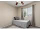 Cozy bedroom with carpet flooring, ceiling fan and a window for natural light at 14008 N 61St Ave, Glendale, AZ 85306