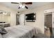 This bedroom features a ceiling fan, carpet flooring, mounted TV, and an ensuite bath at 14008 N 61St Ave, Glendale, AZ 85306