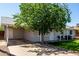 View of single-story house with covered parking and lush lawn at 14008 N 61St Ave, Glendale, AZ 85306