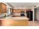 Well-lit kitchen features wood cabinets, stainless steel appliances, tile floors and a breakfast bar at 14008 N 61St Ave, Glendale, AZ 85306