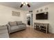 Comfortable living room with tile floors and a view into the kitchen with black appliances at 14008 N 61St Ave, Glendale, AZ 85306