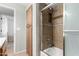Bathroom shower with tiled walls, built in niche, and glass shower door at 14008 N 61St Ave, Glendale, AZ 85306