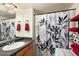 Stylish bathroom with a decorative shower curtain, storage shelves, and a large mirror at 14203 N 19Th Ave # 1031, Phoenix, AZ 85023