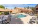 Community pool with ample seating, desert landscaping, and conveniently located near residential buildings at 14203 N 19Th Ave # 1031, Phoenix, AZ 85023