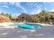 Community pool with sun loungers and chairs, located near the condo buildings and attractively landscaped at 14203 N 19Th Ave # 1031, Phoenix, AZ 85023
