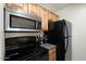 Kitchen featuring updated appliances, including stainless steel microwave and black refrigerator at 14203 N 19Th Ave # 1031, Phoenix, AZ 85023