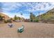 Community playground with spring riders, bordered by attractive landscaping and views of nearby hills at 14203 N 19Th Ave # 1031, Phoenix, AZ 85023