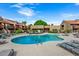 Community pool with ample seating and a building in the background at 14203 N 19Th Ave # 1031, Phoenix, AZ 85023